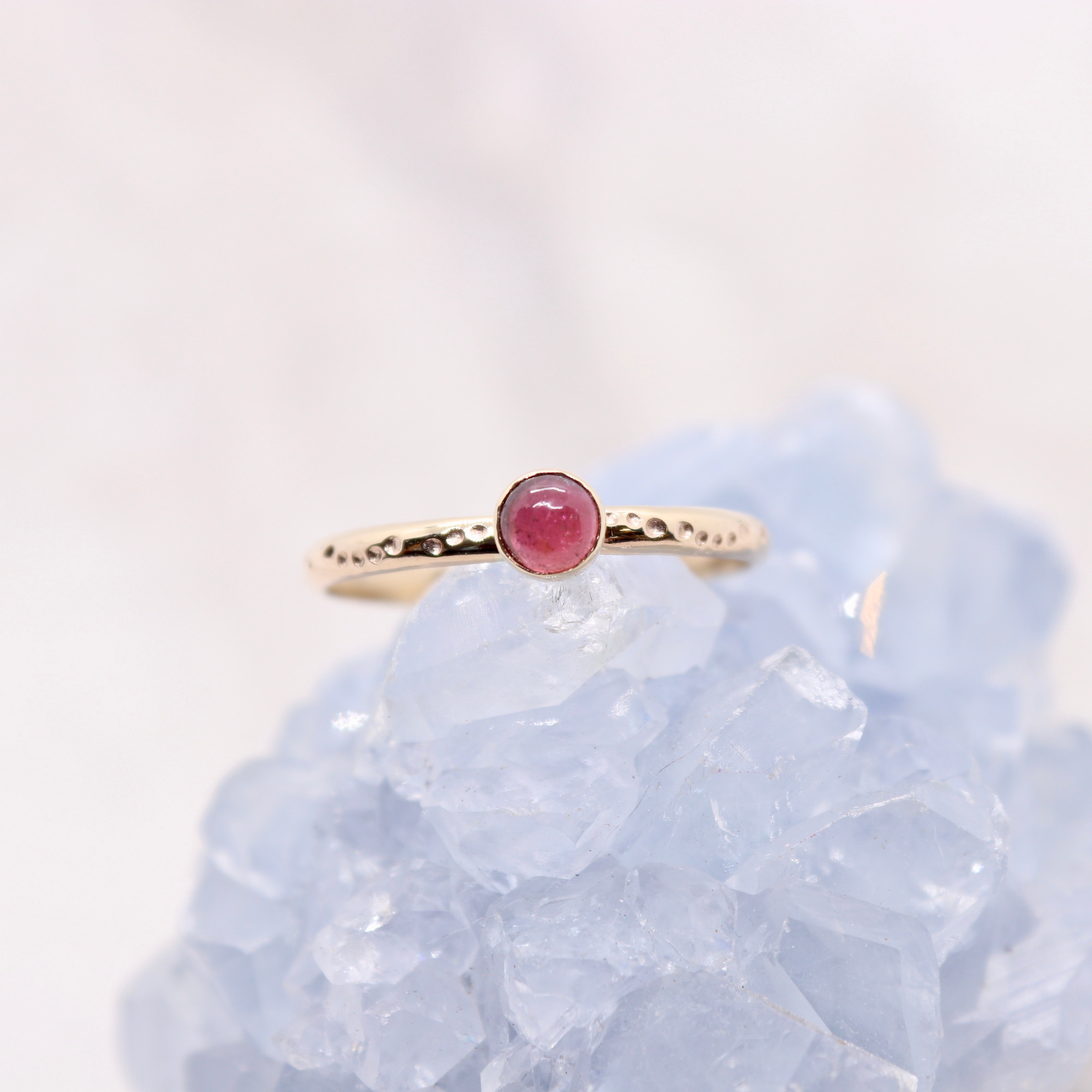 Pink tourmaline gemstone on a solid 14k gold ring band, a unique alternative engagement ring