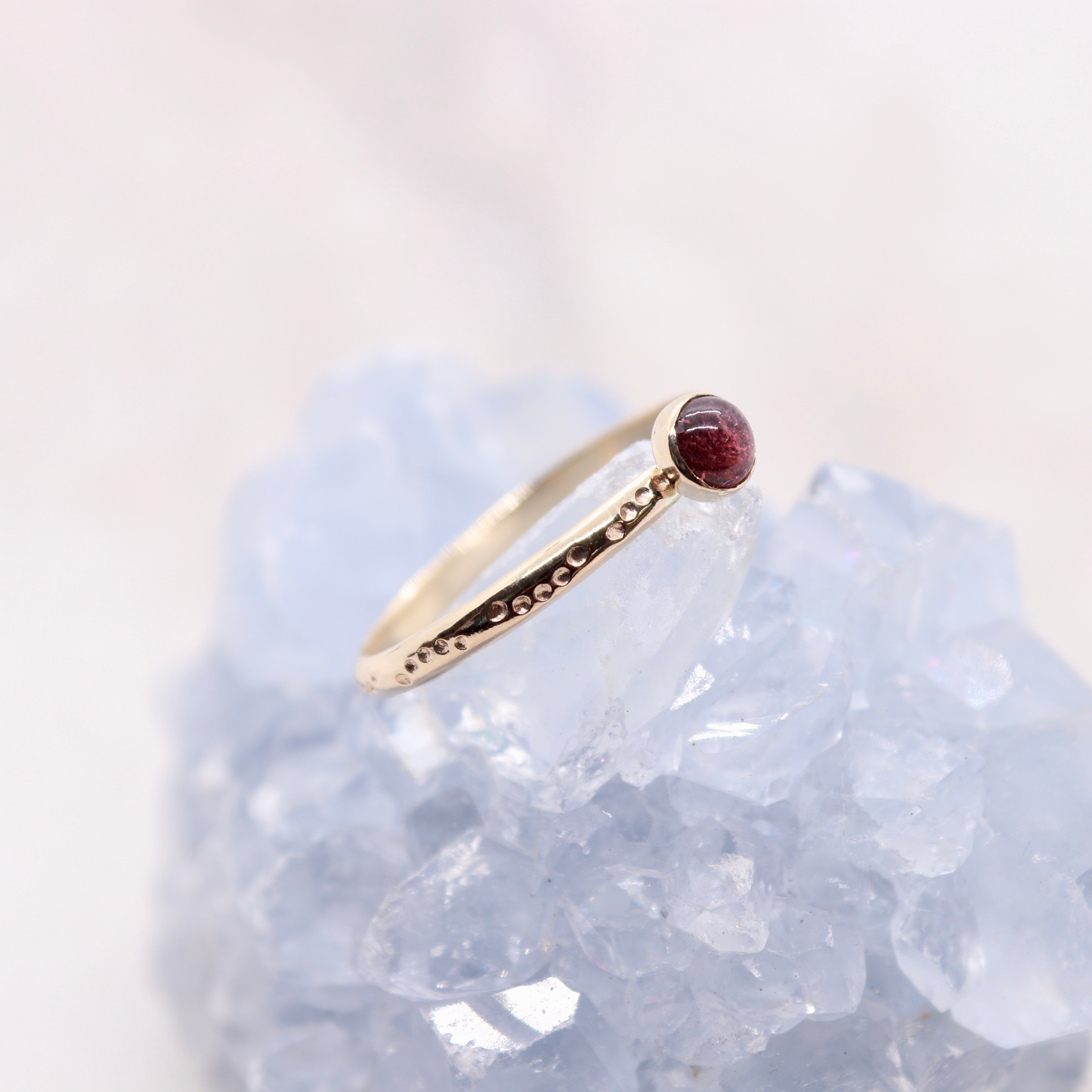 Pink tourmaline gemstone on a solid 14k gold ring band, a unique alternative engagement ring