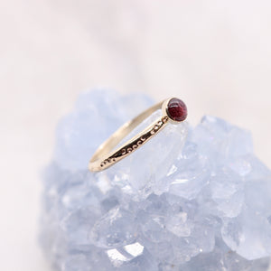 Pink tourmaline gemstone on a solid 14k gold ring band, a unique alternative engagement ring