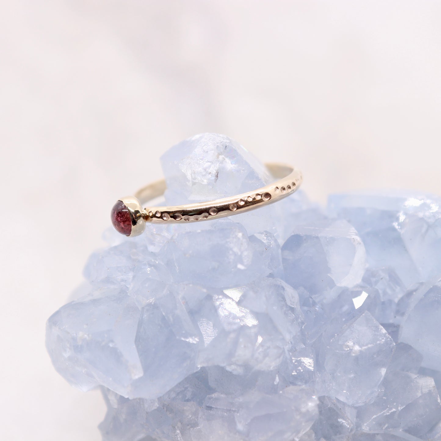 Pink tourmaline gemstone on a solid 14k gold ring band, a unique alternative engagement ring