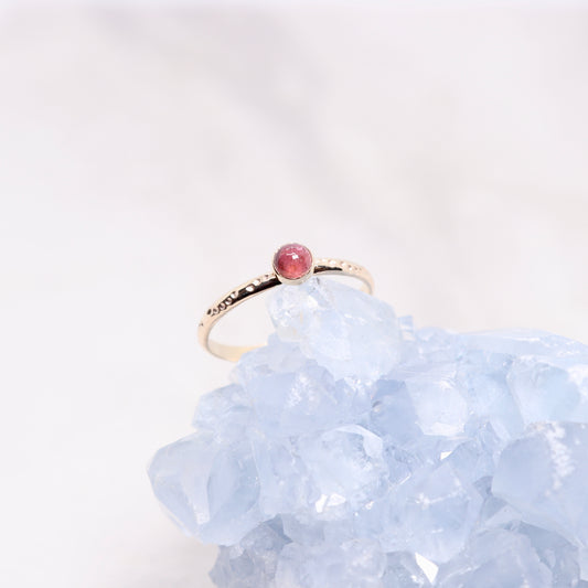 Pink tourmaline gemstone on a solid 14k gold ring band, a unique alternative engagement ring